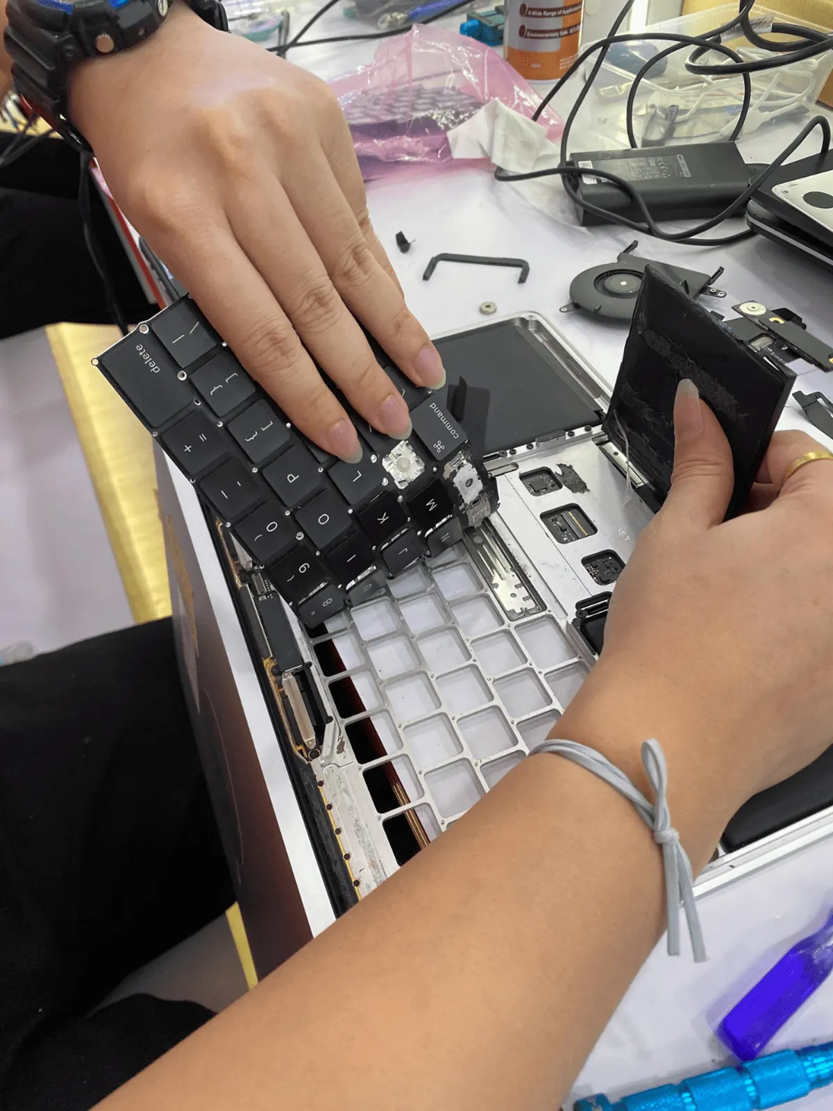 Replacement battery being handled before fitting into a MacBook Pro