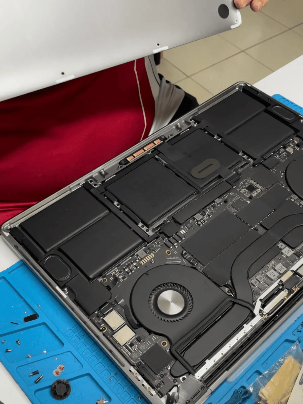 Full internal view of a MacBook with battery and logic board visible